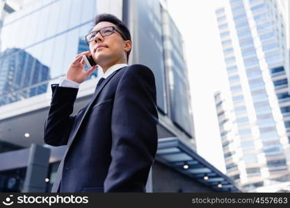 Businessman in city holding his mobile. Technology is a part of my life