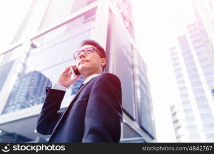 Businessman in city holding his mobile. Technology is a part of my life