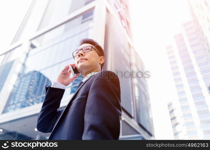 Businessman in city holding his mobile. Technology is a part of my life