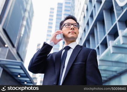 Businessman in city holding his mobile. Technology is a part of my life