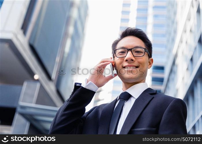 Businessman in city holding his mobile. Technology is a part of my life