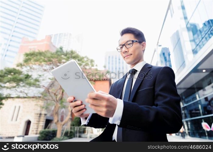Businessman in city holding his notebook. Technology is a part of my life