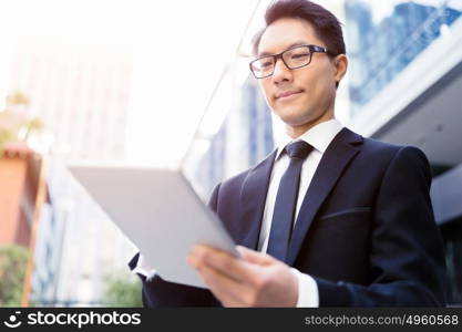 Businessman in city holding his notebook. Technology is a part of my life