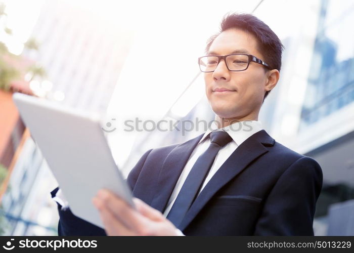 Businessman in city holding his notebook. Technology is a part of my life