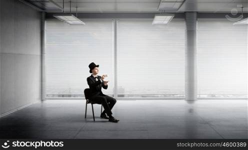Businessman in cylinder drinking coffee. Businessman taking break at office and having cup of hot aromatic coffee