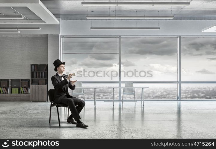 Businessman in cylinder drinking coffee. Businessman taking break at office and having cup of hot aromatic coffee