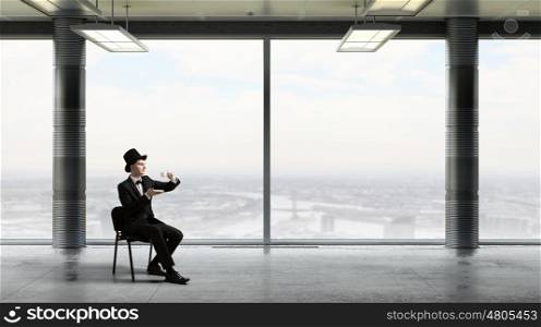 Businessman in cylinder drinking coffee. Businessman taking break at office and having cup of hot aromatic coffee