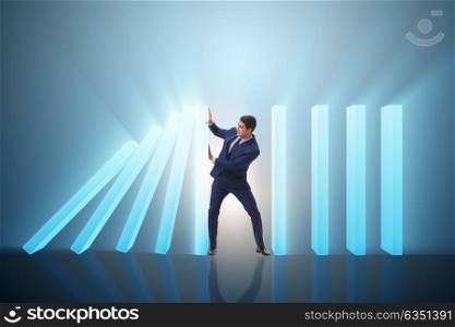 Businessman in domino effect business concept