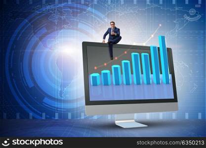 Businessman in economic forecasting concept with charts