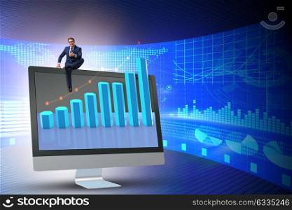 Businessman in economic forecasting concept with charts. The businessman in economic forecasting concept with charts