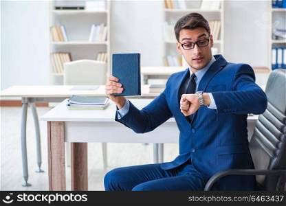 Businessman in executive education concept with book