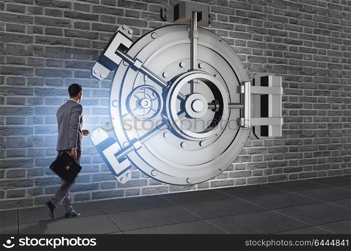 Businessman in front of banking vault door