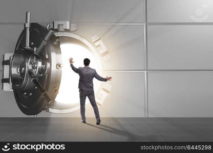 Businessman in front of banking vault door