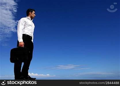 Businessman in front of blue sky