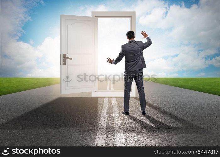 Businessman in front of door in business opportunities concept