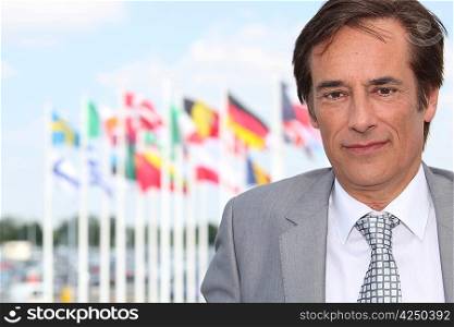 Businessman in front of flags