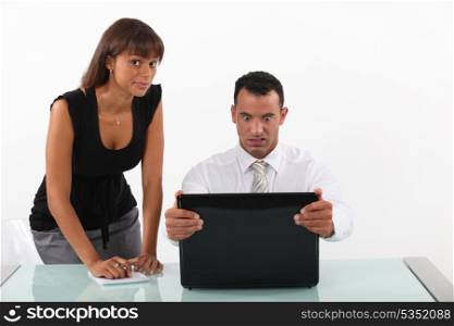 businessman in front of his laptop looking surprised