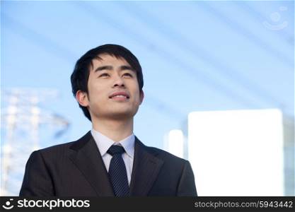 Businessman in Front of Power Lines