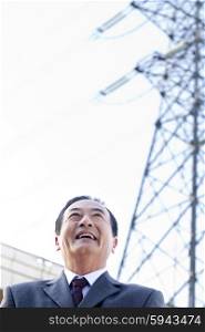 Businessman in Front of Power Lines