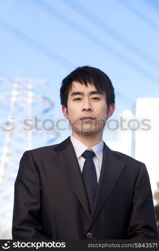 Businessman in Front of Power Lines