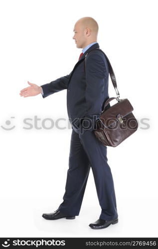 Businessman in full-length stretches out his hand for a handshake. Isolated on white background