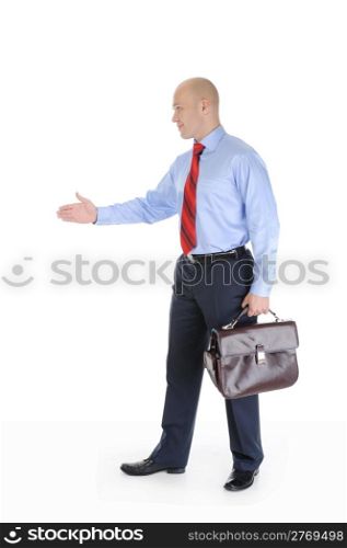 Businessman in full-length stretches out his hand for a handshake. Isolated on white background