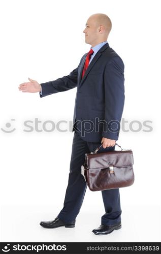 Businessman in full-length stretches out his hand for a handshake. Isolated on white background