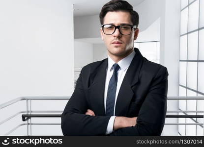 Businessman in glasses and suit, stadium and fireworks on background. Successful football manager concept