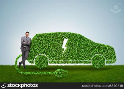 Businessman in green electric car concept