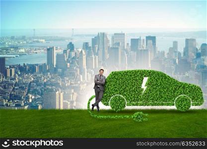 Businessman in green electric car concept