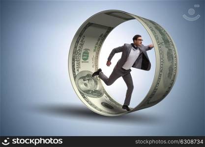 Businessman in hamster wheel chasing dollars
