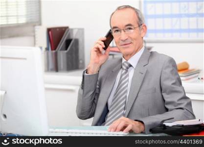 businessman in his office taking a call