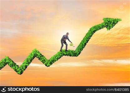 Businessman in investment concept watering financial line chart