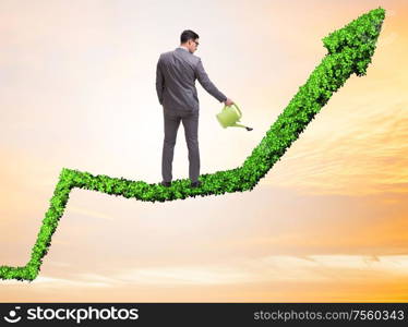 Businessman in investment concept watering financial line chart. The businessman in investment concept watering financial line ch