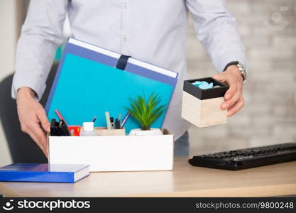 businessman in light modern office with carton box