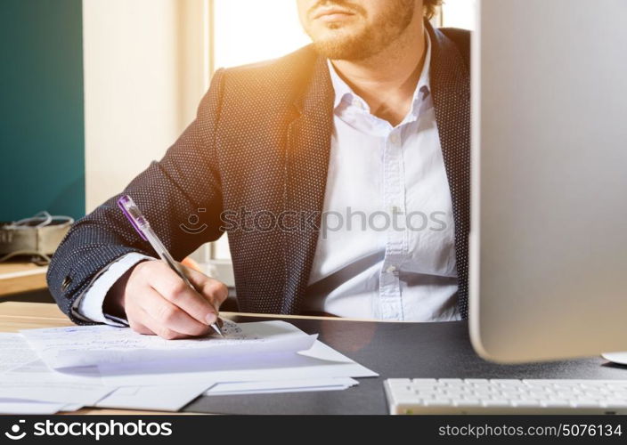 Businessman in loft office. Businessman working computer in modern loft office at sunset