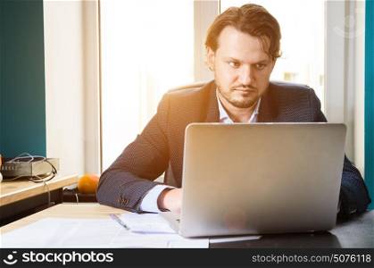 Businessman in loft office. Businessman working laptop in modern loft office at sunset