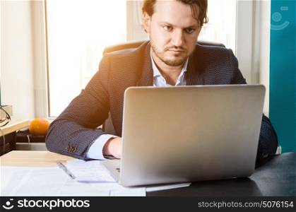 Businessman in loft office. Businessman working laptop in modern loft office at sunset