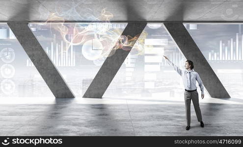 Businessman in modern interior. Businessman in building interior working with media screen