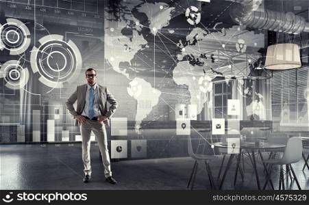 Businessman in modern office. Young elegant businessman in office thinking over business