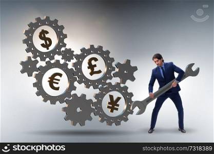 Businessman in multiple currencies concept
