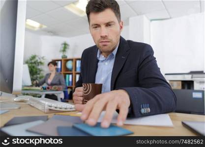 businessman in office checking colours