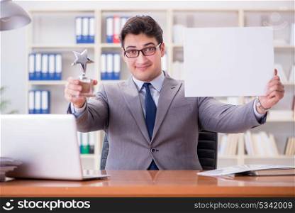 Businessman in office holding a blank message board