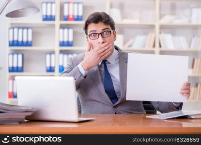 Businessman in office holding a blank message board