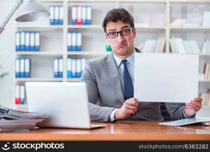 Businessman in office holding a blank message board