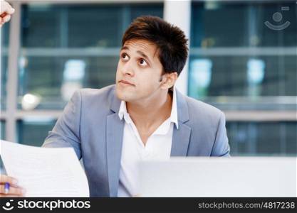 Businessman in office looking at his collegue. I know what you mean