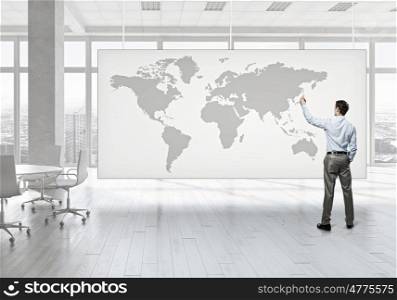 Businessman in office mixed media. Young successful businessman in white office interior