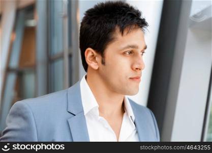 Businessman in office smiling at camera. Success and professionalism in person