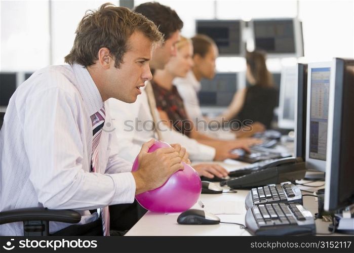 Businessman in office space with a ball