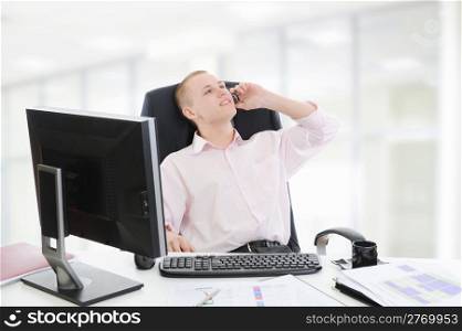 Businessman in office talking on the phone.